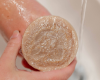 using luffa soap to exfoliate elbow