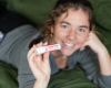 Woman holding a solid lotion stick 