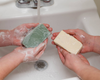 Washing hands with goat milk soaps
